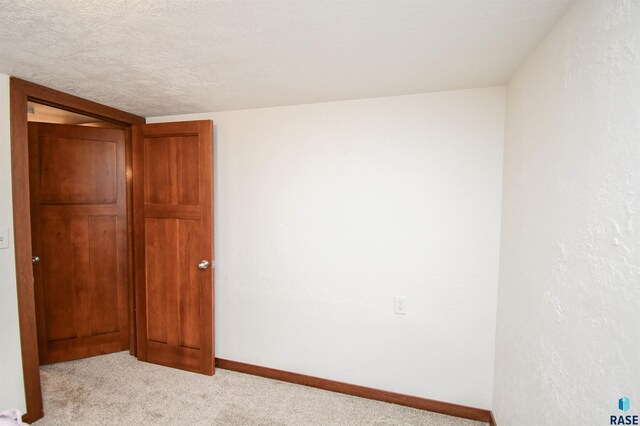 carpeted spare room with baseboards