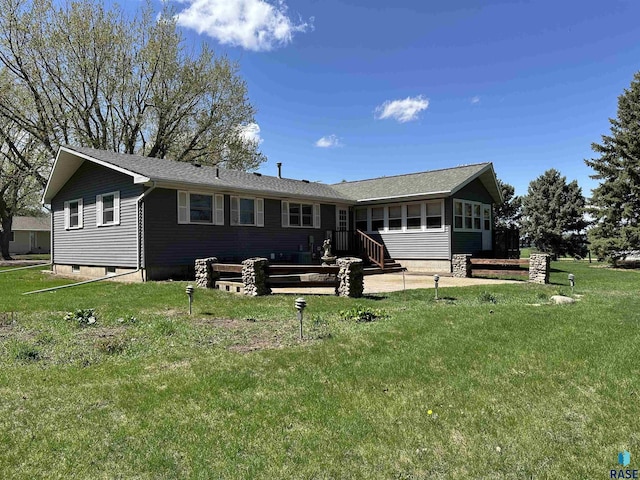 back of house with a yard and a sunroom