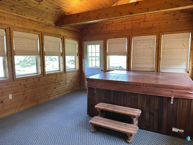 unfurnished sunroom with a hot tub