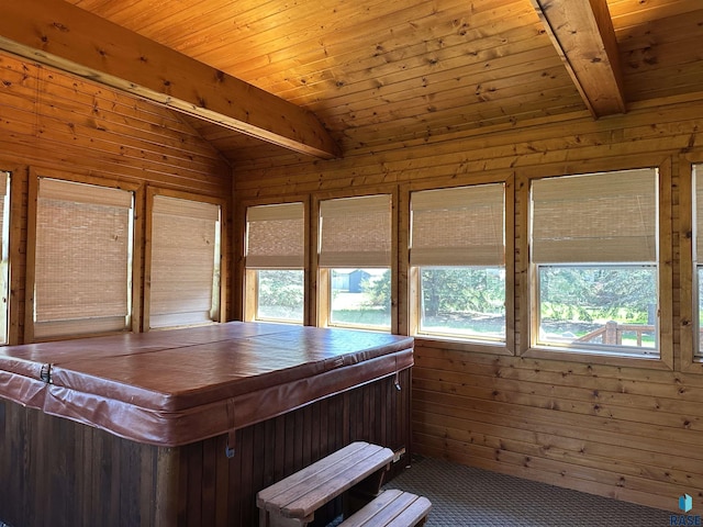 sunroom / solarium with a hot tub and beam ceiling