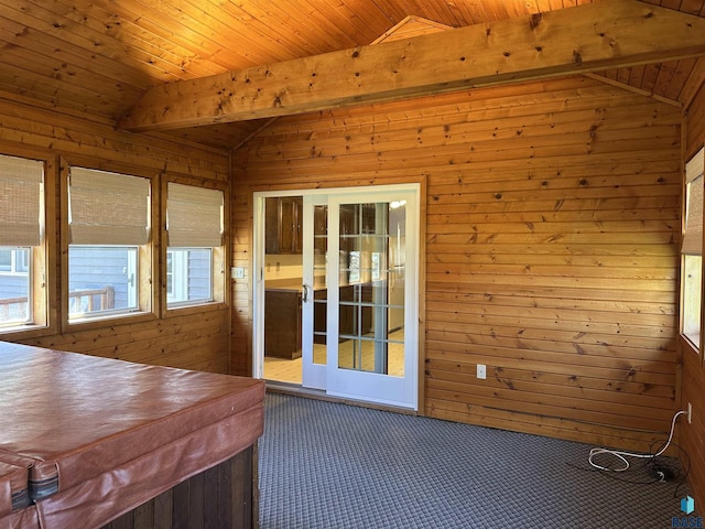 sunroom with a hot tub and beamed ceiling