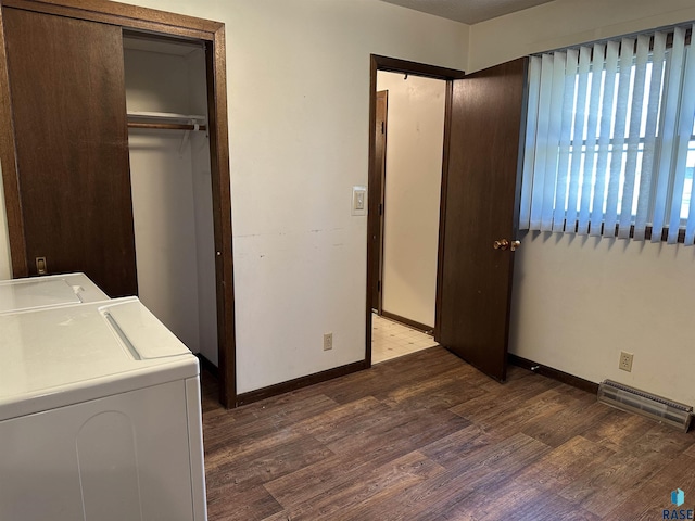 laundry room featuring washer and dryer, laundry area, baseboards, wood finished floors, and visible vents