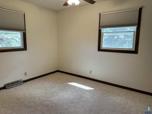 unfurnished room featuring ceiling fan, plenty of natural light, baseboards, and carpet
