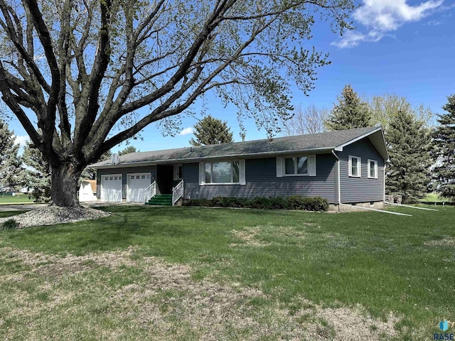 ranch-style house featuring an attached garage and a front yard