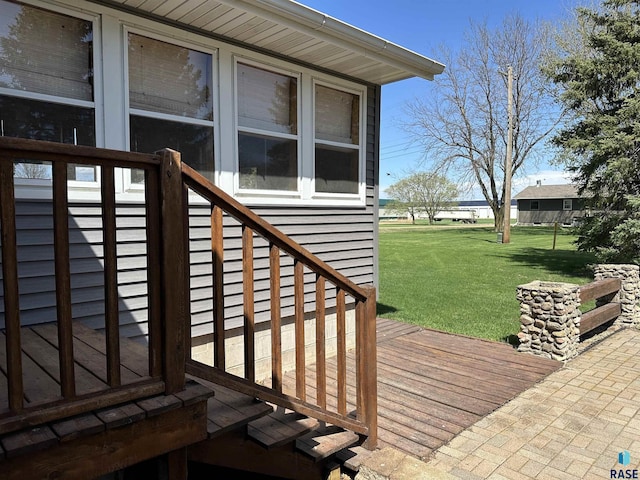 wooden terrace featuring a lawn