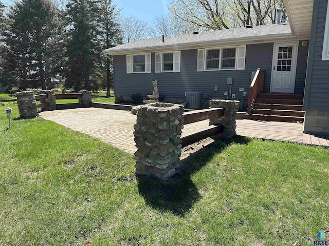 back of house with a yard and cooling unit