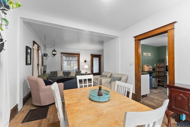 dining room featuring visible vents and wood finished floors