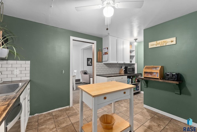 kitchen with decorative backsplash, dark countertops, open shelves, white cabinets, and dishwashing machine