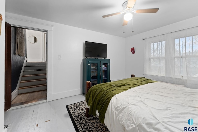bedroom featuring baseboards and ceiling fan
