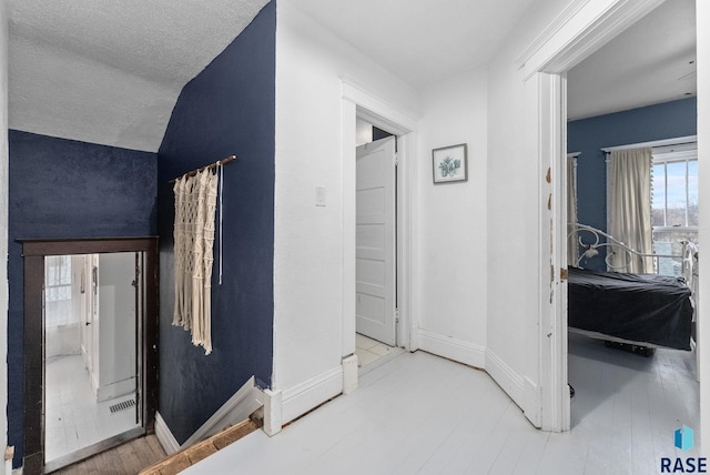 hall featuring baseboards