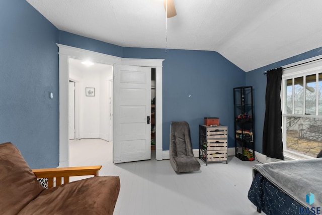 bedroom with baseboards, ceiling fan, and vaulted ceiling