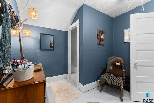bathroom with baseboards, a textured ceiling, and vanity