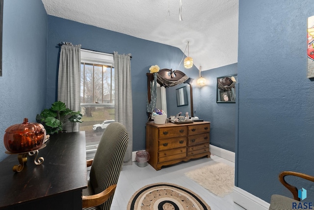 bedroom featuring a textured ceiling, a textured wall, and lofted ceiling