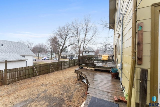 view of yard featuring a residential view, a fenced backyard, and a wooden deck