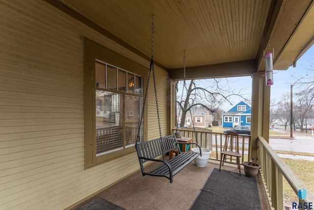view of patio with covered porch and a residential view