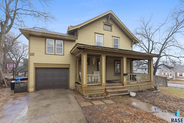 traditional home featuring a garage, covered porch, and driveway