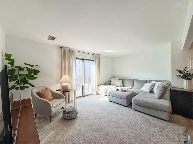 living area with carpet floors and visible vents