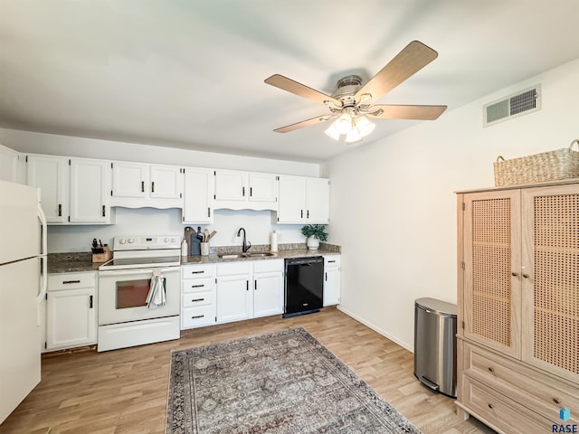 kitchen with visible vents, white appliances, white cabinets, a sink, and dark stone countertops