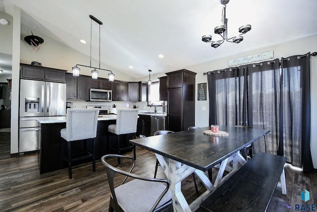 dining space with a chandelier, dark wood-type flooring, lofted ceiling, and recessed lighting