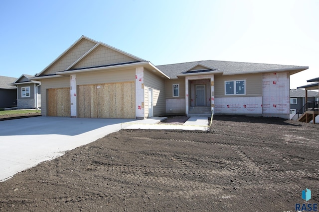 single story home featuring an attached garage and driveway