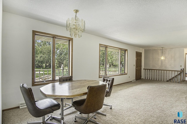 dining area with a wealth of natural light, carpet, a textured ceiling, and a chandelier