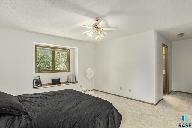 carpeted bedroom with baseboards and a ceiling fan