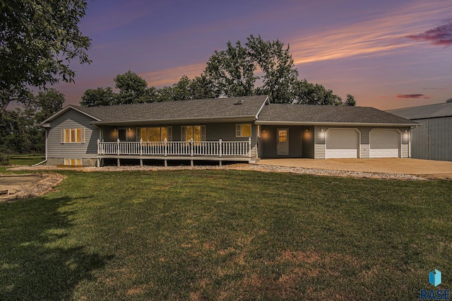 view of front facade featuring a garage, a yard, and concrete driveway