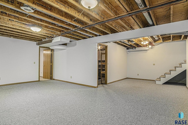finished basement featuring stairs and baseboards