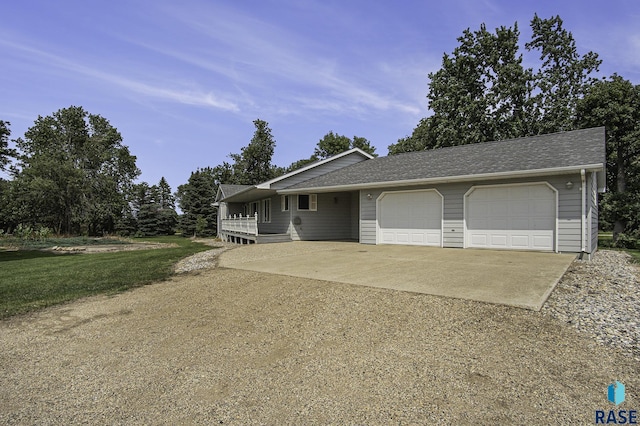 single story home featuring a garage, roof with shingles, and concrete driveway