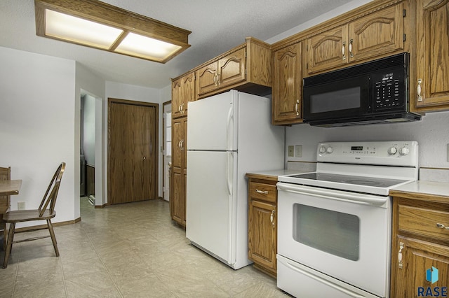 kitchen with brown cabinetry, light countertops, light floors, and white appliances