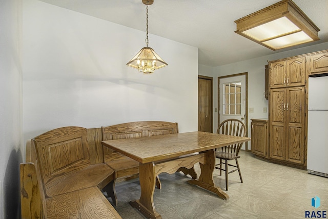 dining room with an inviting chandelier and light floors