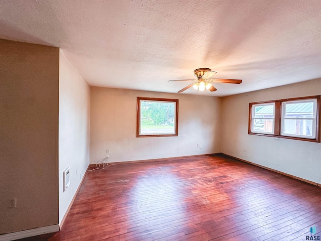 120 SW 2nd St Unit 1 & 2, Wentworth, SD 57075 - spare room with a textured ceiling, plenty of natural light, and hardwood / wood-style floors