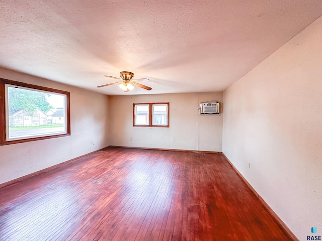120 SW 2nd St Unit 1 & 2, Wentworth, SD 57075 - spare room with wood-type flooring, a ceiling fan, a textured ceiling, and a wall mounted AC