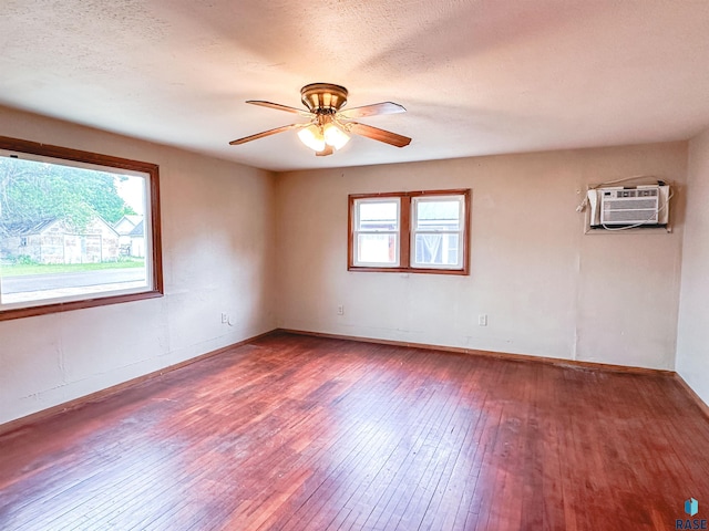 120 SW 2nd St Unit 1 & 2, Wentworth, SD 57075 - unfurnished room featuring wood-type flooring, ceiling fan, a wall mounted AC, and baseboards