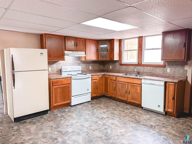 120 SW 2nd St Unit 1 & 2, Wentworth, SD 57075 - kitchen featuring brown cabinetry, a paneled ceiling, a sink, under cabinet range hood, and white appliances