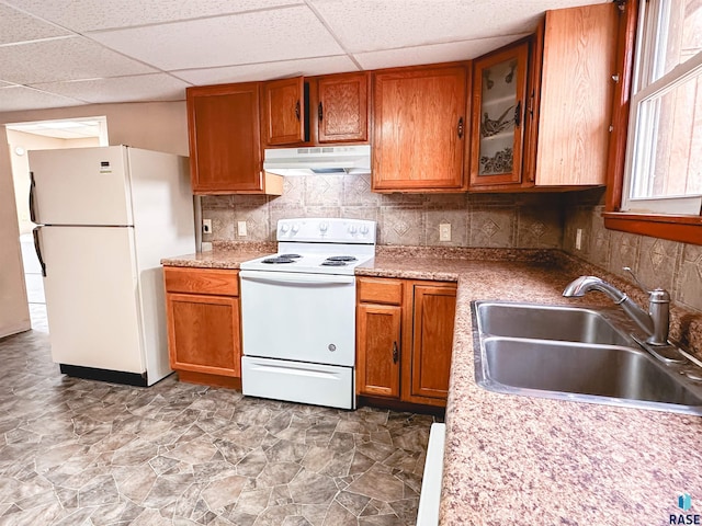 120 SW 2nd St Unit 1 & 2, Wentworth, SD 57075 - kitchen with brown cabinetry, white appliances, a drop ceiling, under cabinet range hood, and a sink