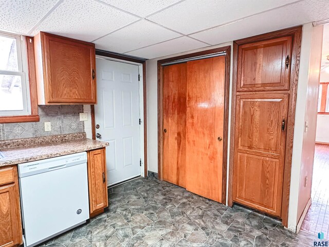 120 SW 2nd St Unit 1 & 2, Wentworth, SD 57075 - kitchen with white dishwasher, light countertops, brown cabinets, and a paneled ceiling