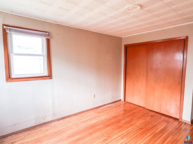 120 SW 2nd St Unit 1 & 2, Wentworth, SD 57075 - unfurnished bedroom featuring a closet and light wood-style flooring