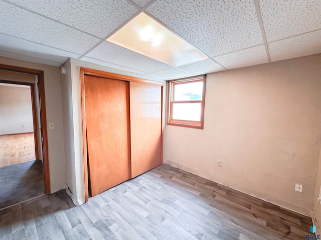 120 SW 2nd St Unit 1 & 2, Wentworth, SD 57075 - unfurnished bedroom featuring wood finished floors, a drop ceiling, and a closet