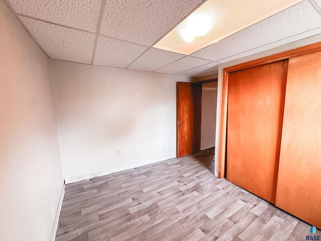 120 SW 2nd St Unit 1 & 2, Wentworth, SD 57075 - unfurnished bedroom featuring a paneled ceiling, wood finished floors, and a closet