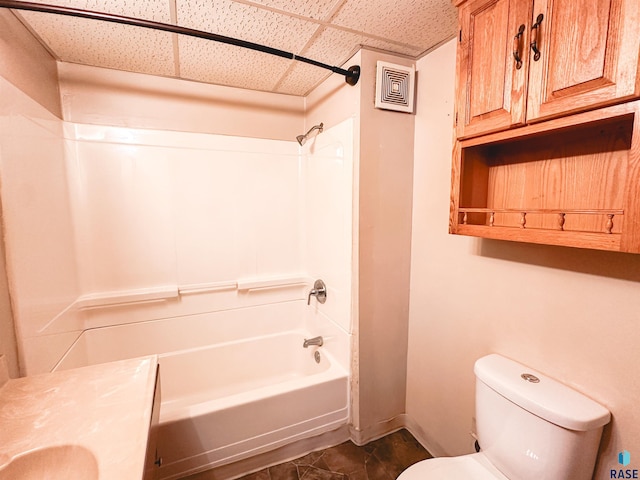 120 SW 2nd St Unit 1 & 2, Wentworth, SD 57075 - bathroom with toilet, baseboards, a drop ceiling, bathing tub / shower combination, and visible vents