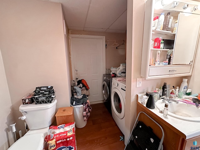 120 SW 2nd St Unit 1 & 2, Wentworth, SD 57075 - laundry room featuring separate washer and dryer, laundry area, a sink, and wood finished floors