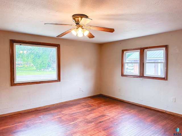 120 SW 2nd St Unit 1 & 2, Wentworth, SD 57075 - spare room featuring wood-type flooring, a textured ceiling, baseboards, and ceiling fan
