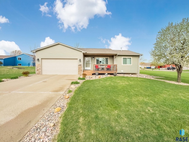 ranch-style home featuring an attached garage, driveway, stone siding, and a front yard