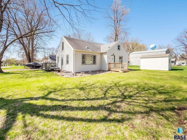 409 Boxelder St, Valley Springs, SD 57068 - rear view of property with a chimney, a yard, and a deck