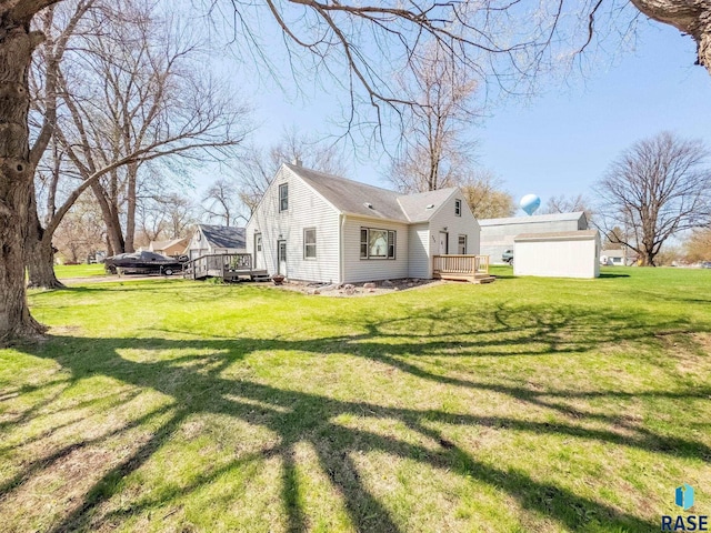 409 Boxelder St, Valley Springs, SD 57068 - back of property with a lawn and a wooden deck