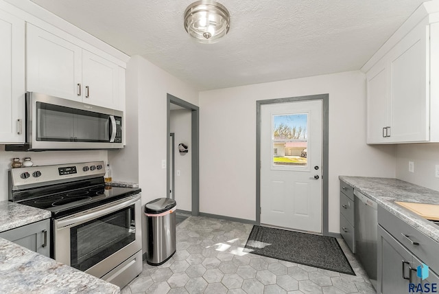409 Boxelder St, Valley Springs, SD 57068 - kitchen with light countertops, stainless steel appliances, and white cabinetry