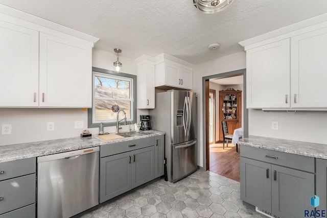 409 Boxelder St, Valley Springs, SD 57068 - kitchen with a sink, gray cabinets, white cabinetry, and stainless steel appliances