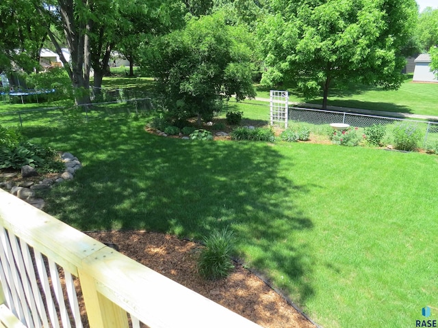 view of yard featuring a fenced backyard and a trampoline