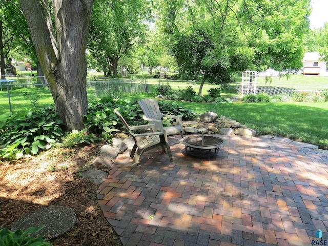 view of patio featuring fence and an outdoor fire pit